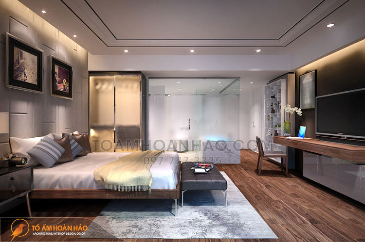 Màu xám ghi lạnh chủ đạo của căn phòng được trung hòa lại bởi nội thất và sàn gỗ nâu trầm